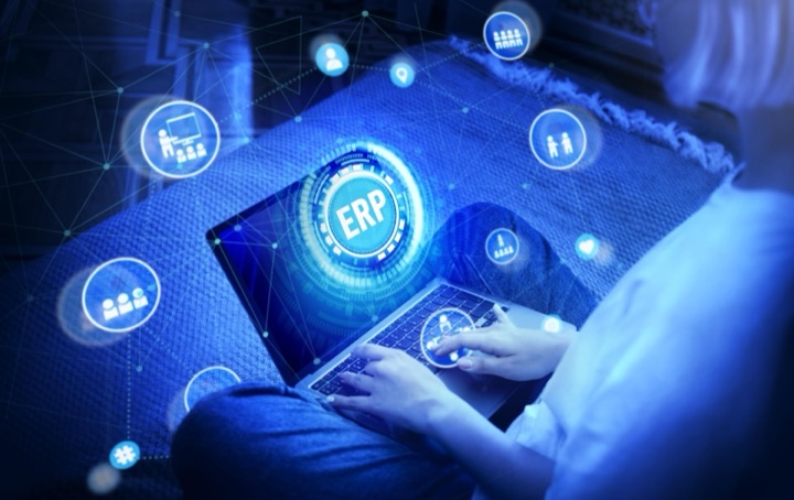 Professional using a laptop with a glowing ERP digital interface representing SAP S/4HANA and SAP Business One modernization